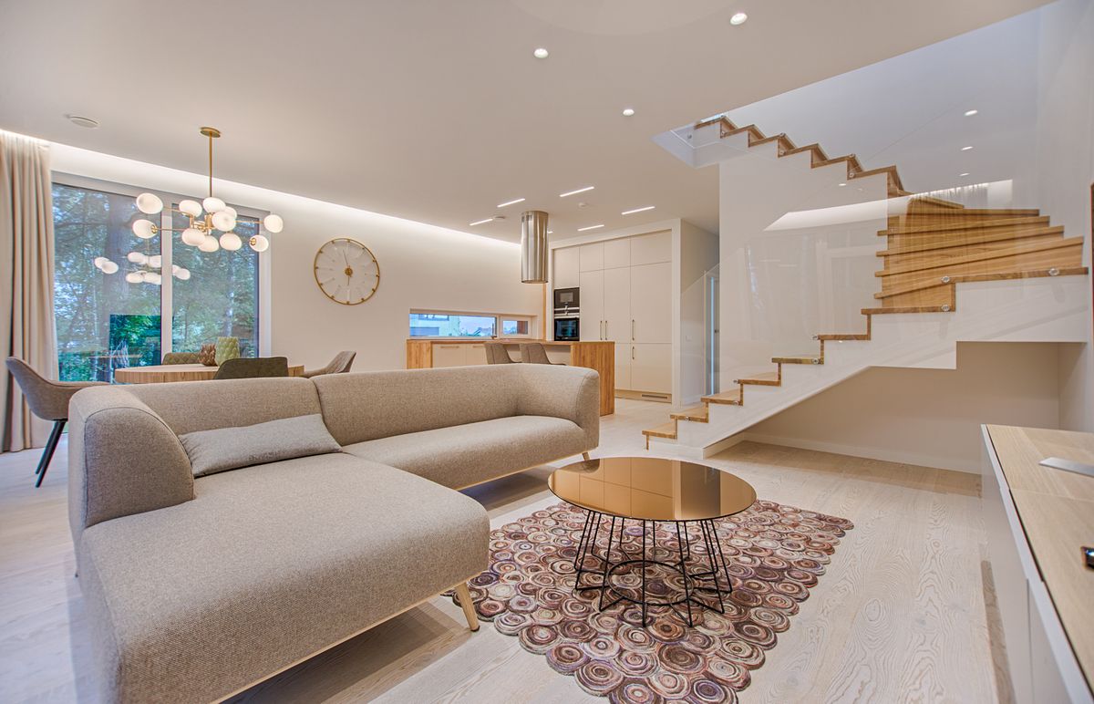 A contemporary living room with neutral tones and a sofa.